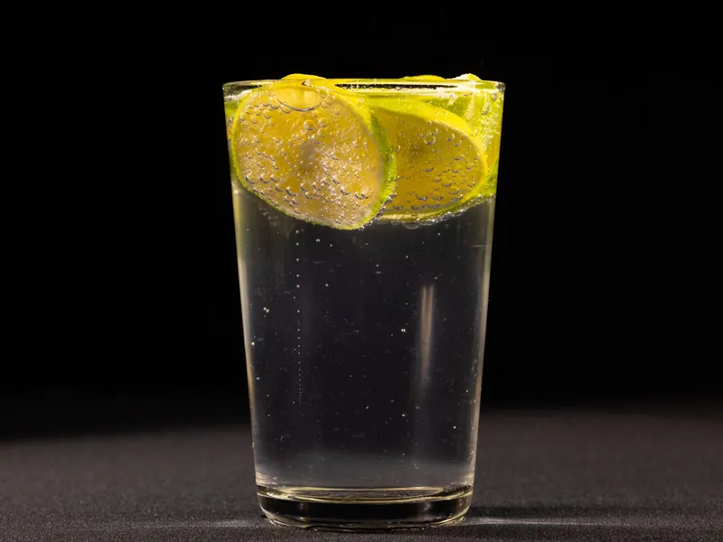 Vodka soda with lime wheels in a tall glass
